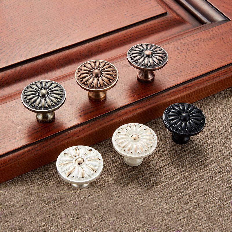 A collection of colorful flower-shaped ceramic knobs on a wooden surface.