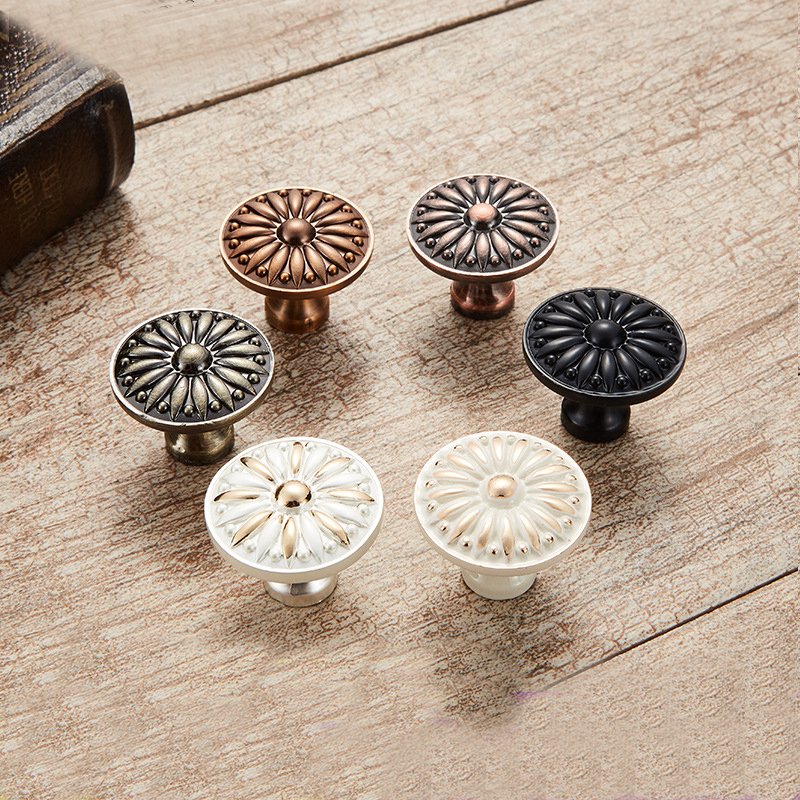 A split image showing colorful flower knobs on a white cabinet and pastel knobs on a light wood cabinet.