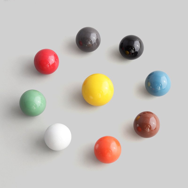 Pastel and Vibrant Cabinet Pulls Collection A vibrant assortment of pastel and high-saturation cabinet pulls arranged on a neutral background.